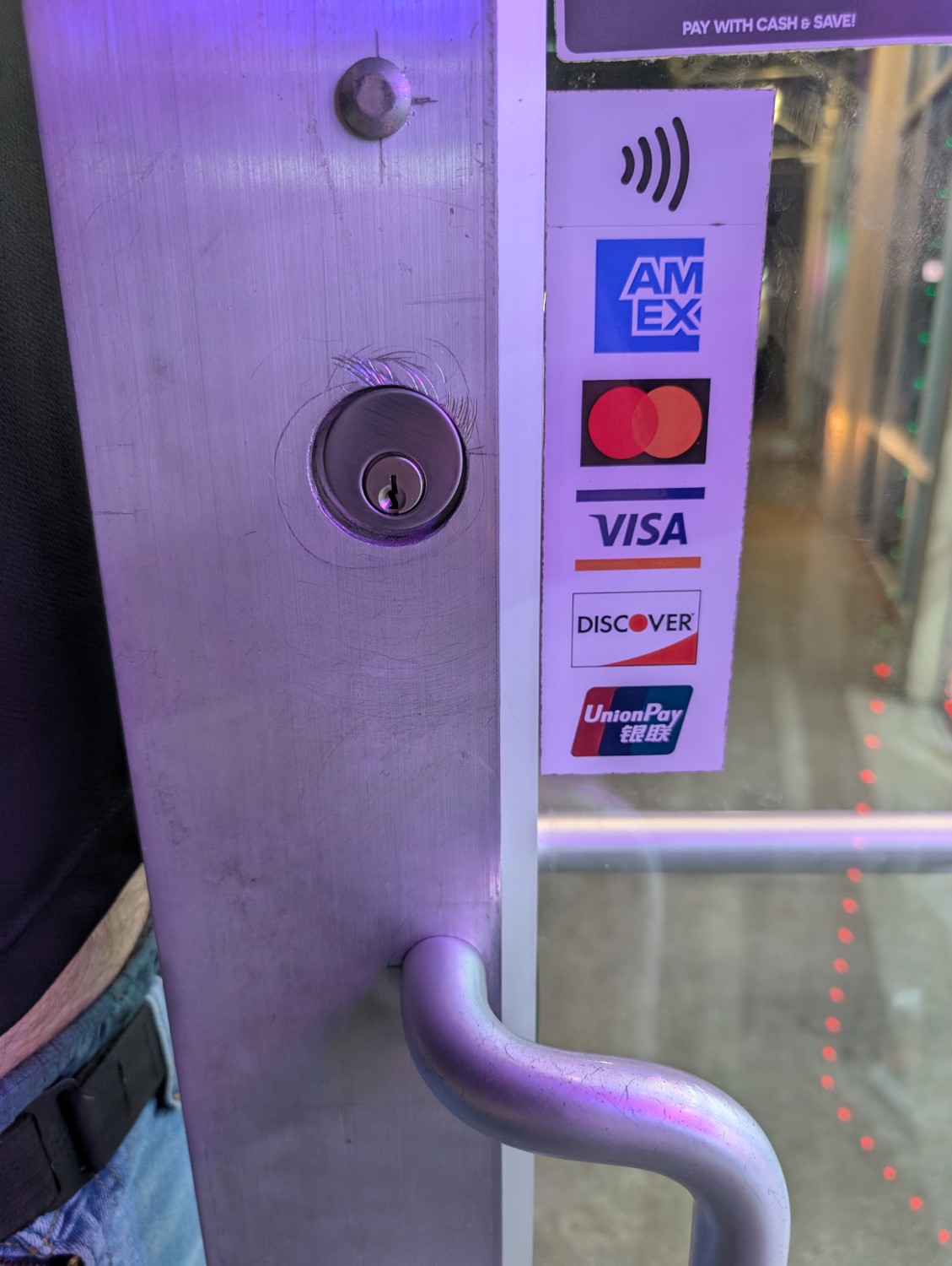 Mortise lock cylinder installed on a commercial glass and metal storefront door