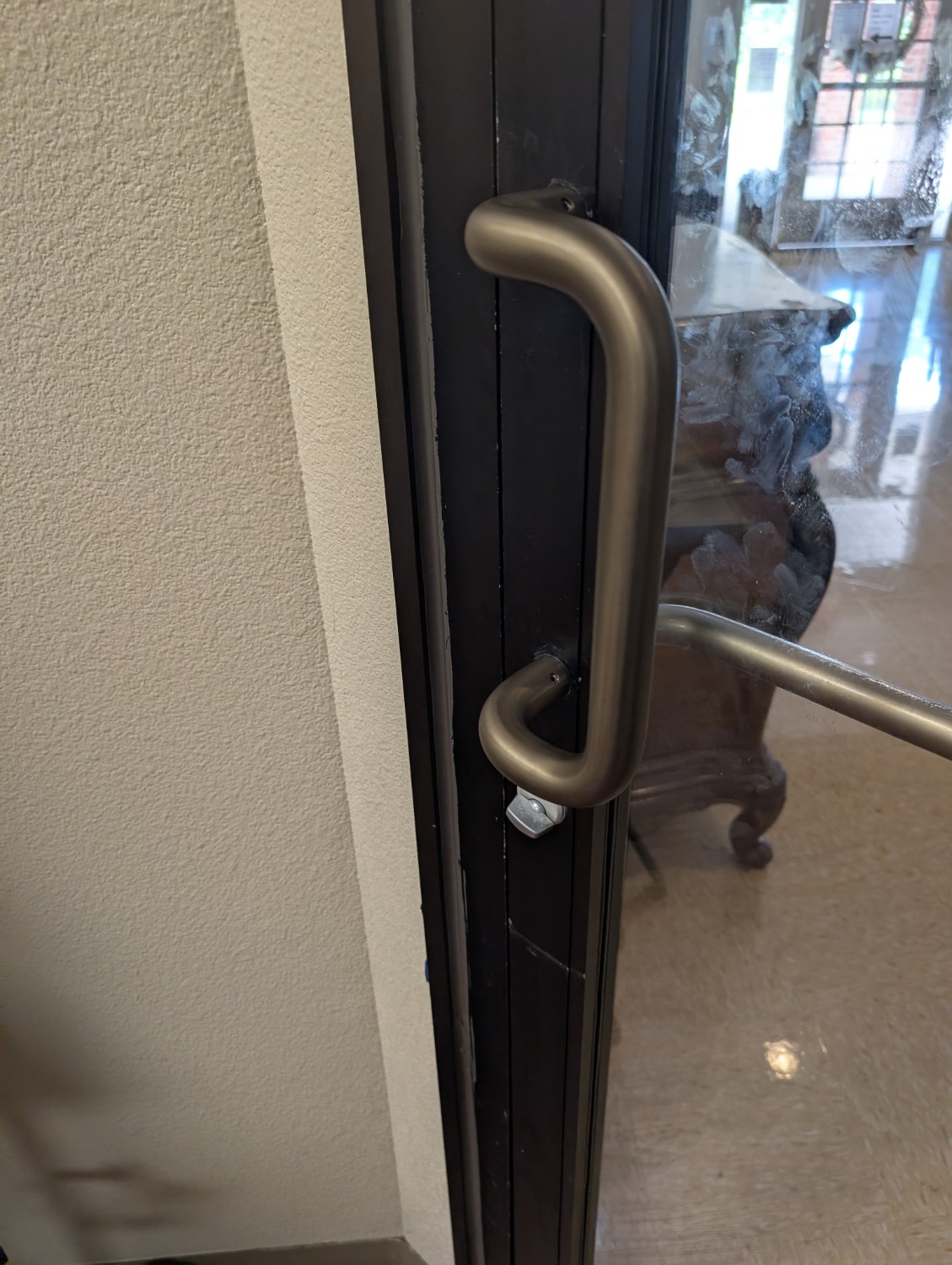 Commercial pull handle installed on a glass office door