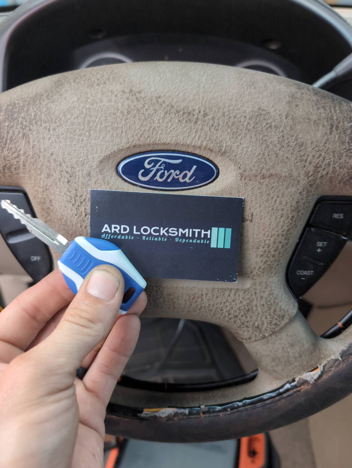 Completed Ford Expedition replacement key documented inside the vehicle with an ARD Locksmith card