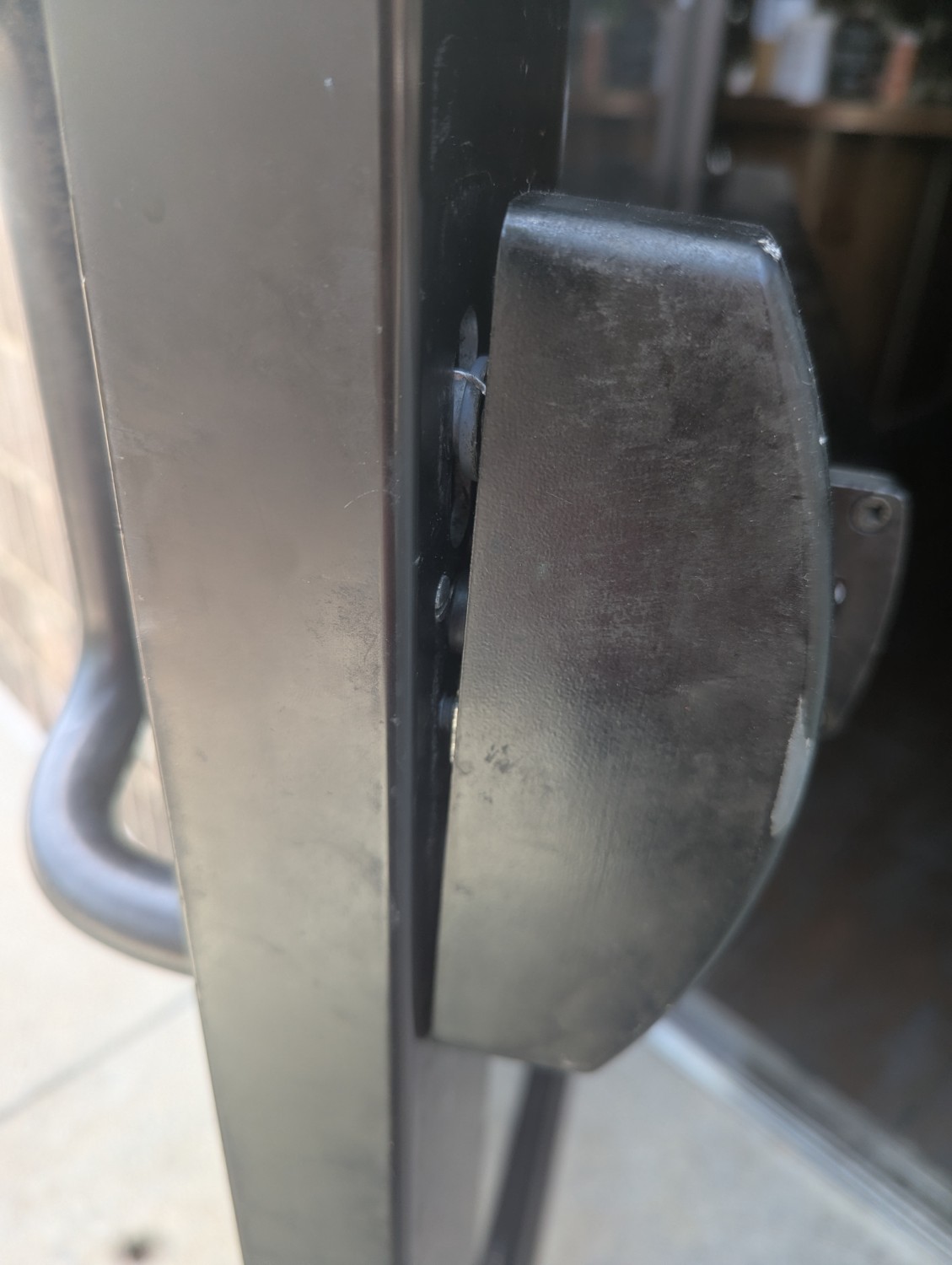 Commercial panic-bar hardware documented on a glass entry door