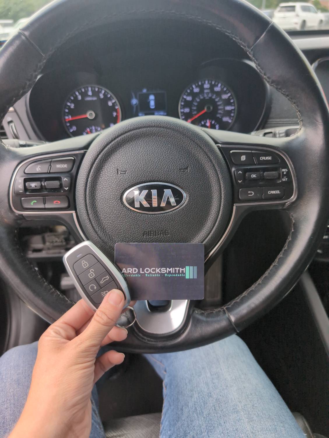 Completed Kia smart key documented inside a 2018 Optima with an ARD Locksmith card