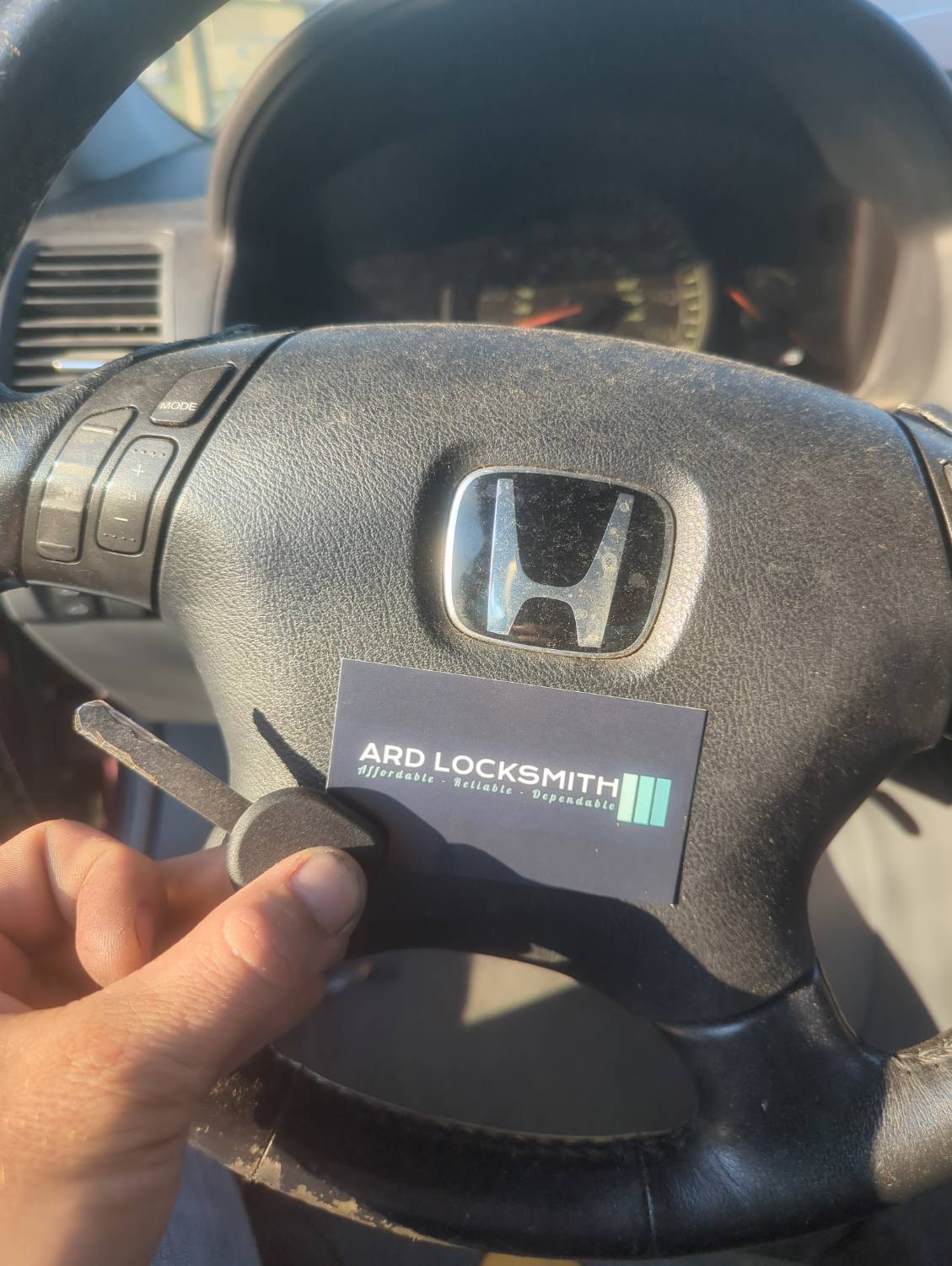 Completed Honda key documented inside a 2003 Accord with an ARD Locksmith card