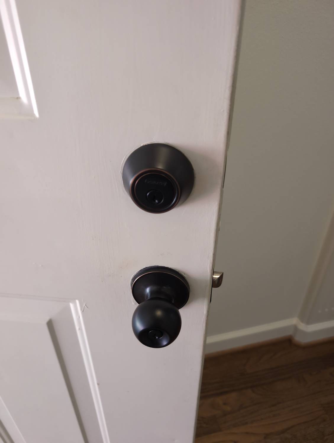 Residential deadbolt and doorknob documented during a whole-home rekey service