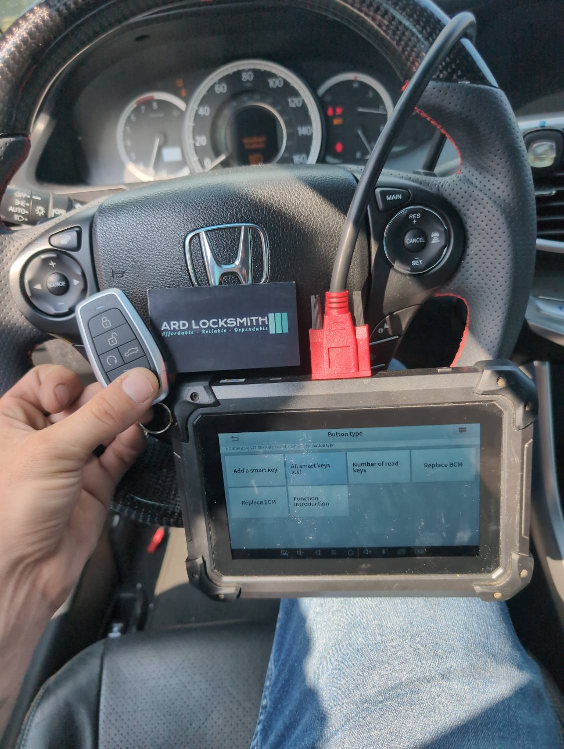 Completed Honda Accord smart key documented with programming equipment and an ARD Locksmith card