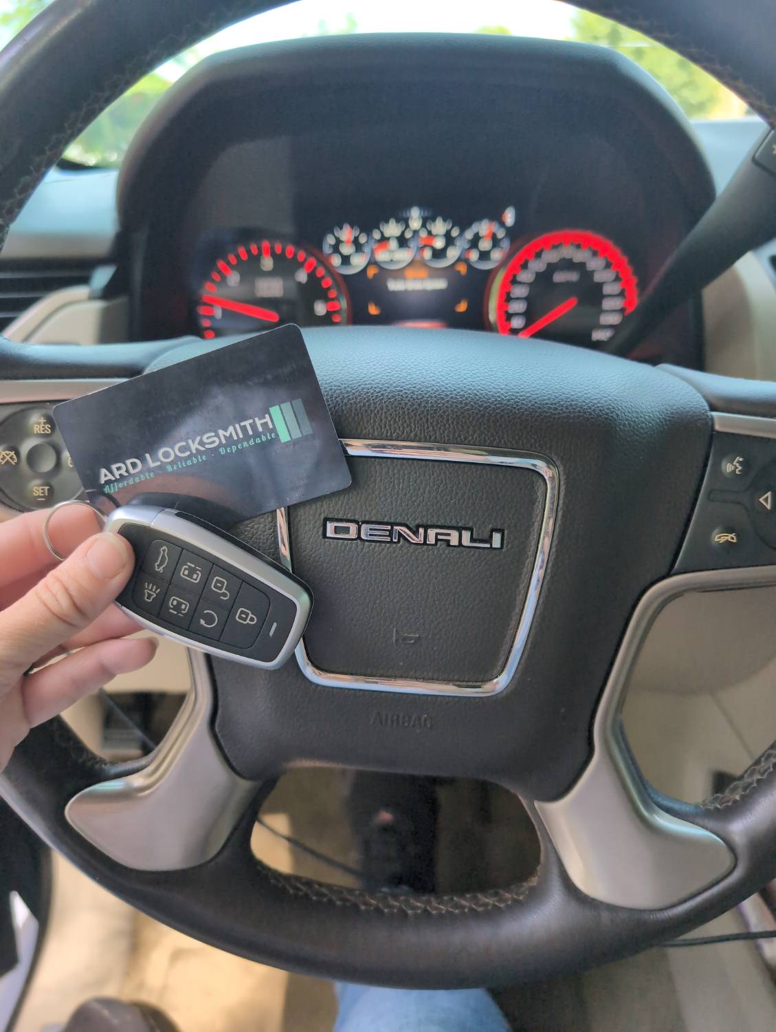 Completed GMC Yukon Denali smart key documented inside the vehicle with an ARD Locksmith card