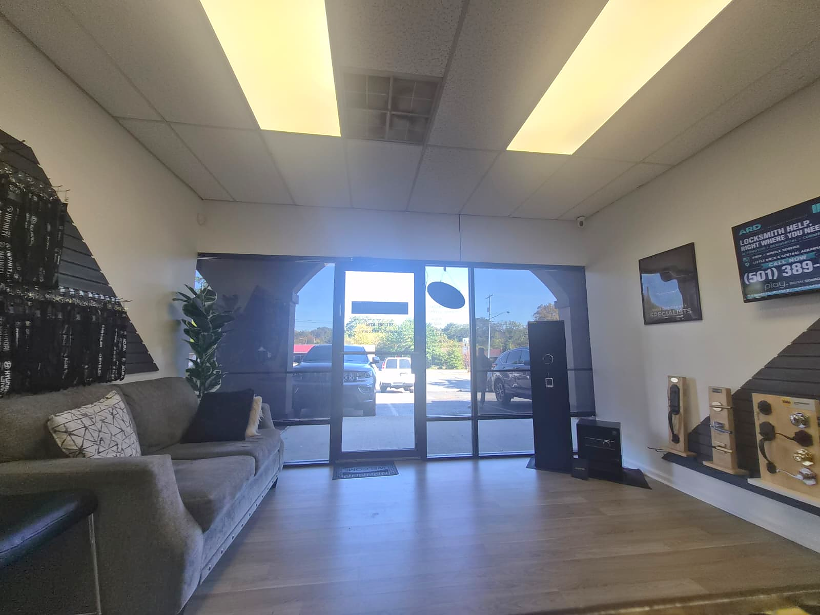 View toward the entrance from inside the ARD Locksmith shop, with seating and lock displays