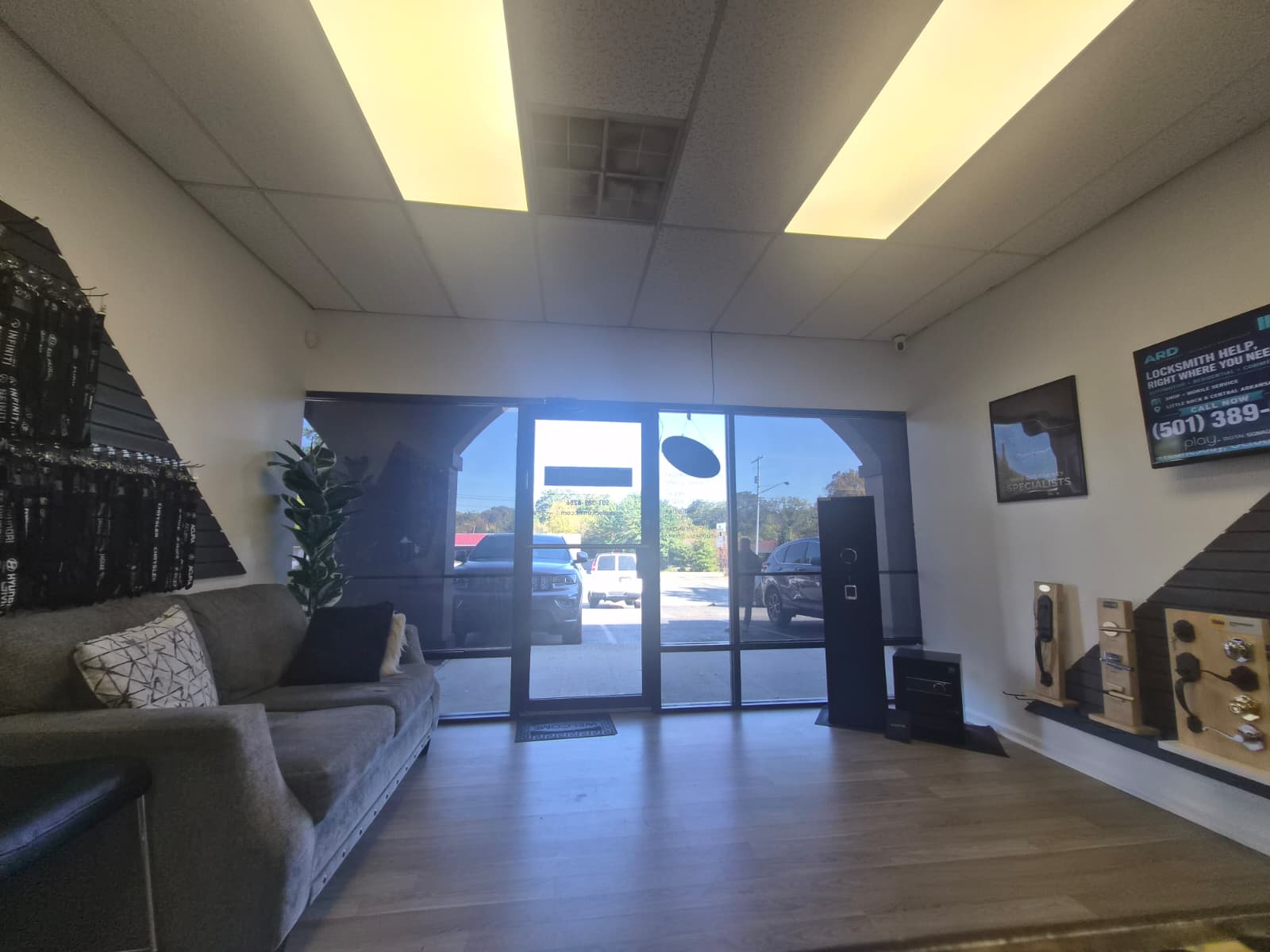 View toward the entrance from inside the ARD Locksmith shop, with seating and lock displays